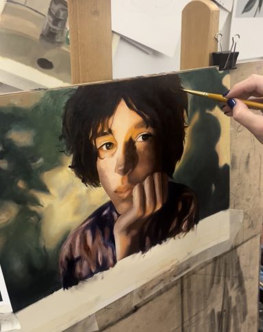 Retrato de un joven pensativo con luz suave y fondo desenfocado.